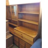 A 1970's Nathan teak glazed door and shelved sideboard with cupboards below