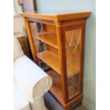 A modern yew three shelf bookcase with carved Corrinthean column detail