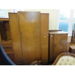 A 1930's oak bedroom suite comprising a single door wardrobe,