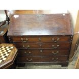 A large Victorian mahogany bureau on bracket feet with fitted interior and four long drawers