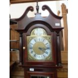 A modern Grandfather clock with brass dial