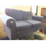 A modern blue upholstered two seater sofa and matching armchair