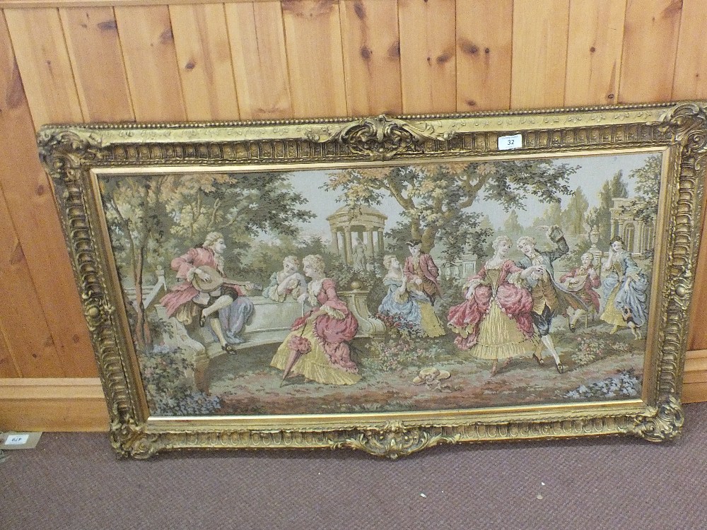 A gilt framed tapestry picture of an outdoor scene,