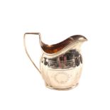 A silver cream jug,