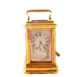 A miniature brass carriage clock with painted figure and floral porcelain panels,