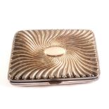 A heavy silver cigarette case with spiral decoration,