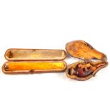 An amber cheroot holder with gold band plus a small Meerschaum cheroot holder