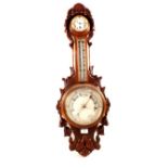 An aneroid barometer with clock in leaf carved oak case (cracked glass)