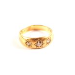 An 18ct gold three stone diamond gypsy ring,