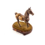 A bronzed figure of a prancing horse,