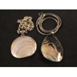 Two large silver mounted shell pendants,