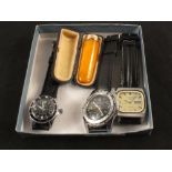 A cased cigar holder with amber mouthpiece and 15ct gold mount plus three wristwatches