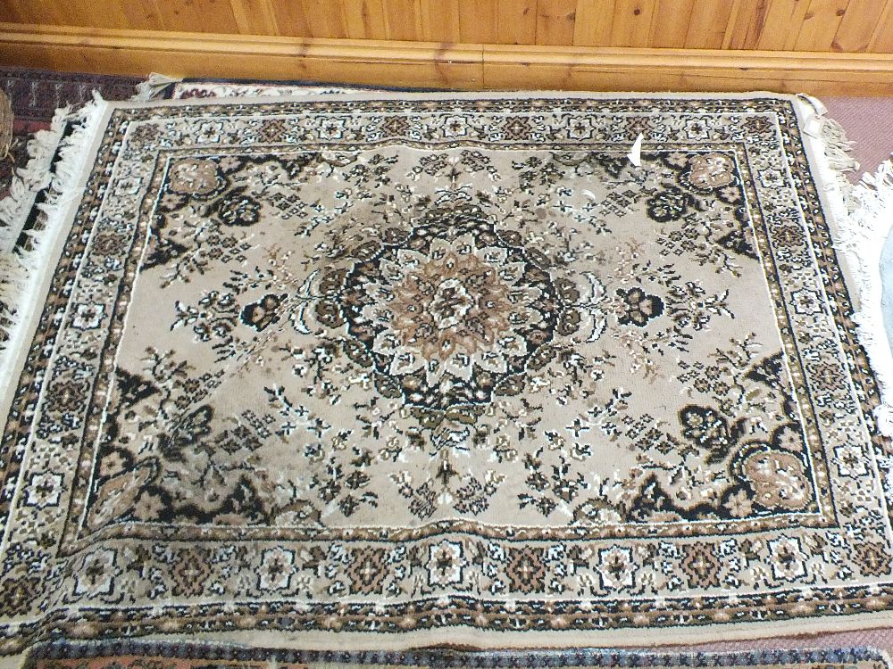 Three floral wool rugs