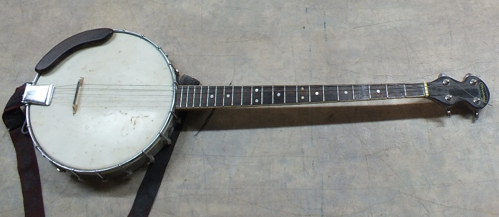 A cased Woodring four string banjo,