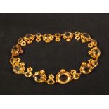 A gold choker necklace set with oval citrine stones