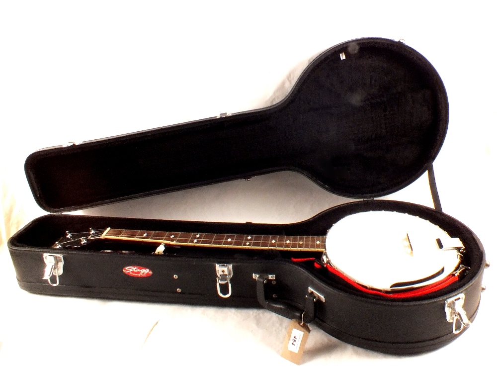 A cased Ridgewood five string banjo