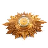 A giltwood sunburst wall clock