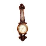 An aneroid barometer in heavily carved oak case (cracked glass)