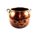 A Georgian copper seamed base cauldron with riveted decoration to the sides