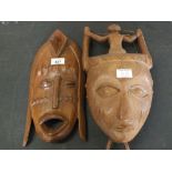 Two African carved wooden masks