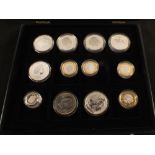 A coin case containing 2 and 5 pound coins and commemorative