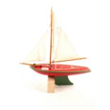 A Star Yacht of Birkenhead wooden pond yacht in red and green,