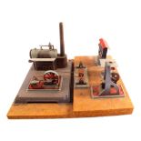 A tin plate stationary steam engine powering three accessories