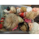 A box of various dolls