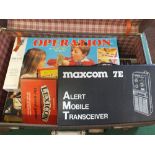 A case of board games plus Maxcom 7E Alert Mobile Transceiver