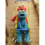 A Sesame St double buggy with figures