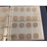 A coin album containing twenty one 2 pound coins,