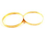 Two gold bangles with engraved decoration,