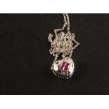 A 14ct white gold heart shaped pendant set with rubies and diamonds in 14ct white gold chain