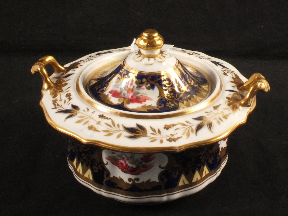 An early 19th Century sucrier with blue ground and gilding with floral reserves