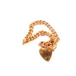 A 9ct gold bracelet (converted from a watch chain) with padlock heart shaped clasp,