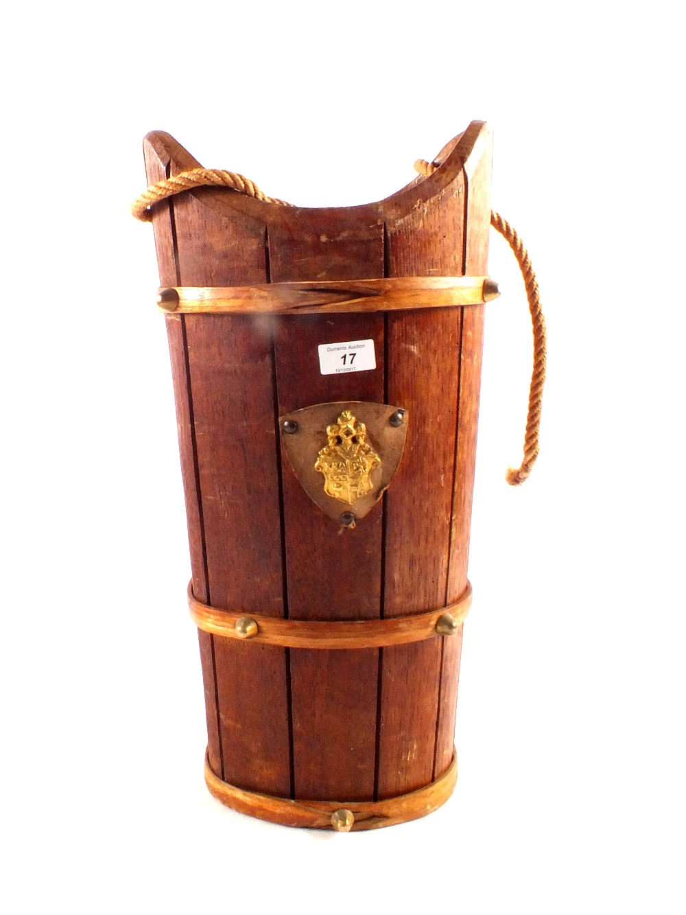 An oak stick stand with gilt metal armorial shield