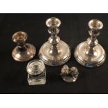 A pair of silver squat candlesticks (non matching dates), a single silver squat candlestick,