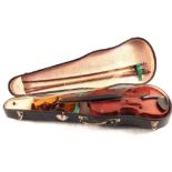 A cased violin and two bows