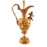 A gilt metal ewer table lamp with cherub decoration