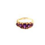 A 9ct gold five stone amethyst ring with ornate shoulders,