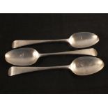 Three silver serving spoons with monogrammed handles,