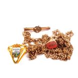 A rolled gold brooch, gold plated chain,