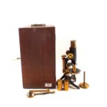 A cased brass and steel microscope,
