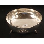 A white metal fruit bowl with relief panels,