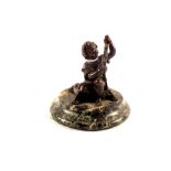 A bronze of a seated boy,