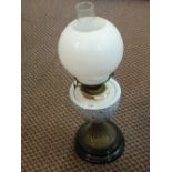 A brass and milk glass oil lamp