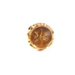 An 18ct gold ring with palm tree and sword insignia