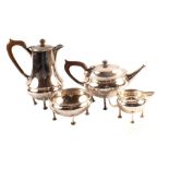 A hammered silver four piece tea set by A.E.