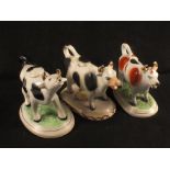 Three various cow creamers