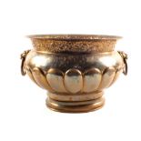 A brass jardiniere with lion ring handles